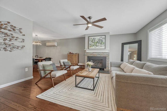 5071 S Boston St, Greenwood Village, CO 80111 - living room with an AC wall unit, wood finished floors, ceiling fan, baseboards, and a fireplace