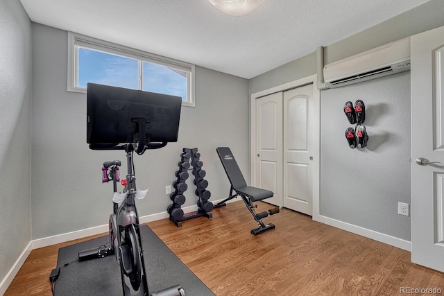 5071 S Boston St, Greenwood Village, CO 80111 - workout room featuring an AC wall unit, baseboards, and wood finished floors