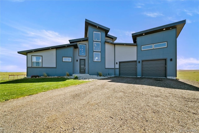 11680 Imboden Rd, Hudson, CO 80642 - modern home with gravel driveway, a garage, and a front yard