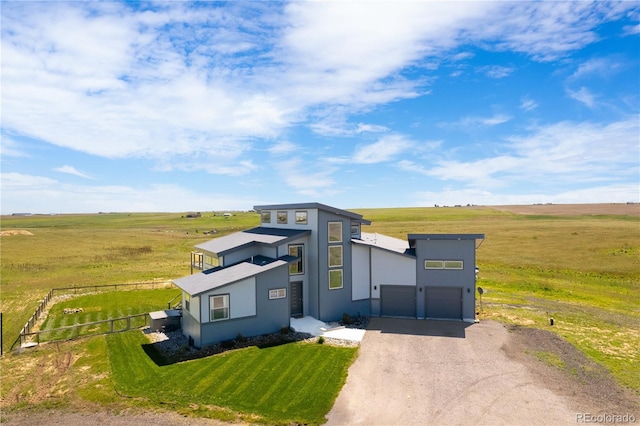 11680 Imboden Rd, Hudson, CO 80642 - modern home with stucco siding, dirt driveway, a view of countryside, and an attached garage