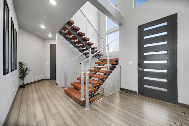 11680 Imboden Rd, Hudson, CO 80642 - entryway with stairs, light wood-style flooring, recessed lighting, and a high ceiling