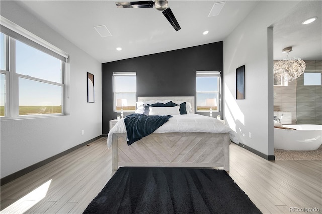 11680 Imboden Rd, Hudson, CO 80642 - bedroom with multiple windows, light wood-type flooring, vaulted ceiling, recessed lighting, and a ceiling fan