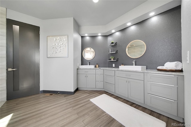 11680 Imboden Rd, Hudson, CO 80642 - bathroom with wood finished floors, double vanity, recessed lighting, and a textured wall
