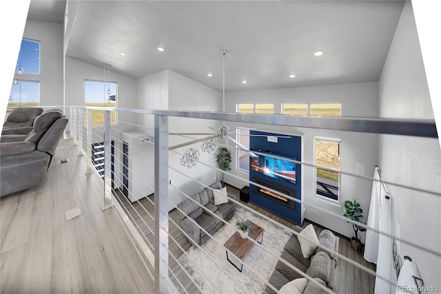 11680 Imboden Rd, Hudson, CO 80642 - hallway featuring wood finished floors, recessed lighting, an upstairs landing, and lofted ceiling