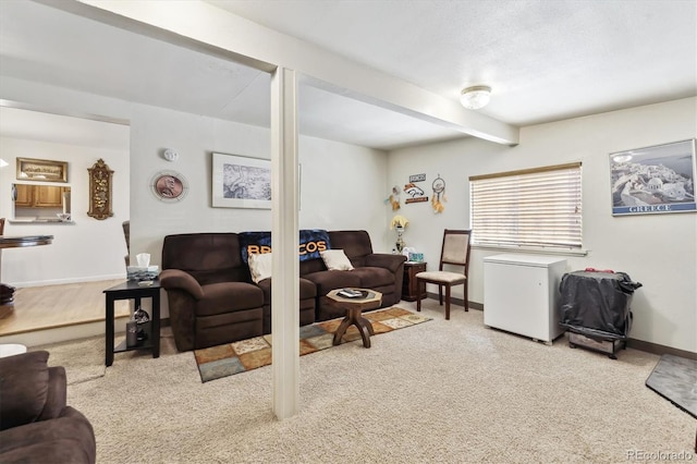 living area featuring beamed ceiling, carpet flooring, and baseboards