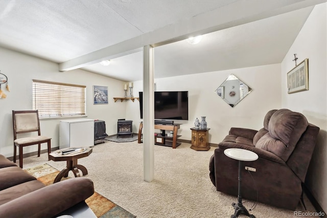 carpeted living area featuring beamed ceiling, a wood stove, and baseboards