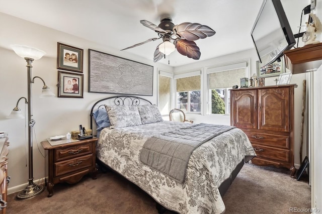 bedroom featuring dark carpet, baseboards, and a ceiling fan