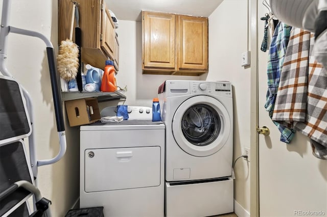 clothes washing area with cabinet space and washing machine and clothes dryer