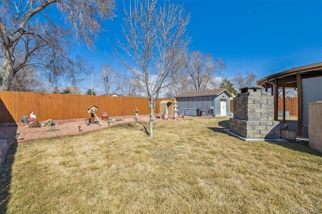 view of yard featuring an outdoor structure and a fenced backyard