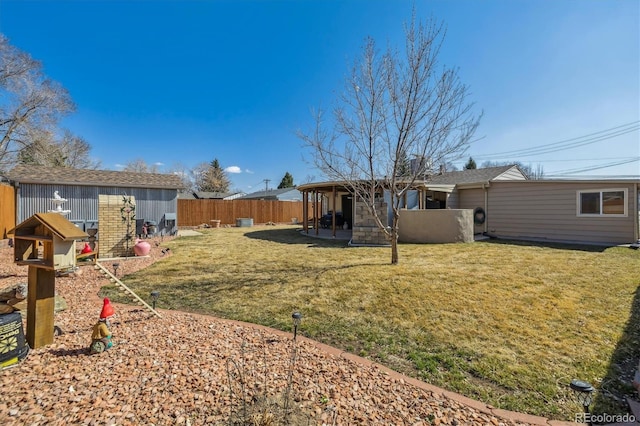 view of yard featuring an outbuilding and a fenced backyard