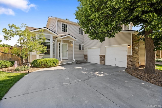 15157 E Nassau Ave, Aurora, CO 80014 - view of front facade featuring driveway, brick siding, and an attached garage
