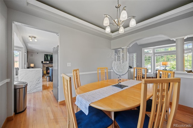 15157 E Nassau Ave, Aurora, CO 80014 - dining area with ornate columns, light wood finished floors, arched walkways, and plenty of natural light