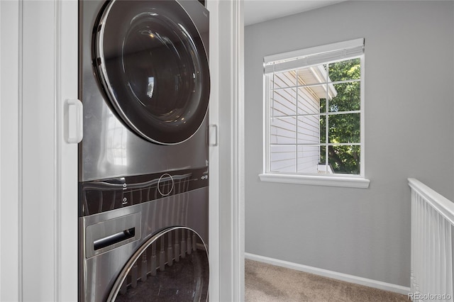 15157 E Nassau Ave, Aurora, CO 80014 - laundry area with stacked washer and clothes dryer, carpet, and healthy amount of natural light