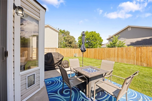 15157 E Nassau Ave, Aurora, CO 80014 - fenced backyard featuring a grill, an outdoor fire pit, and a patio area