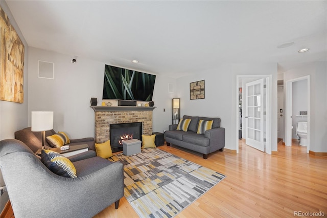 15157 E Nassau Ave, Aurora, CO 80014 - living room featuring wood finished floors, a fireplace, and recessed lighting