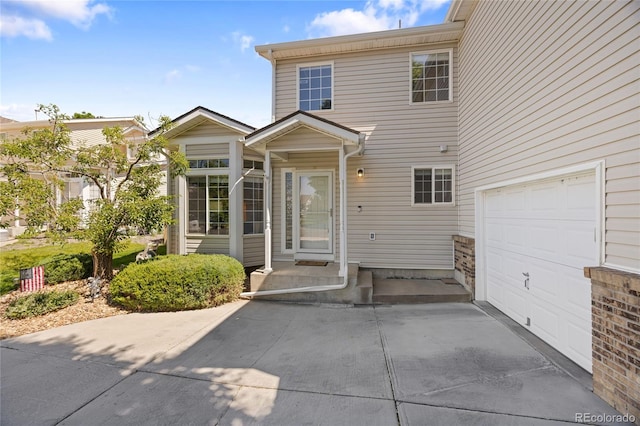 15157 E Nassau Ave, Aurora, CO 80014 - view of exterior entry featuring concrete driveway and a garage