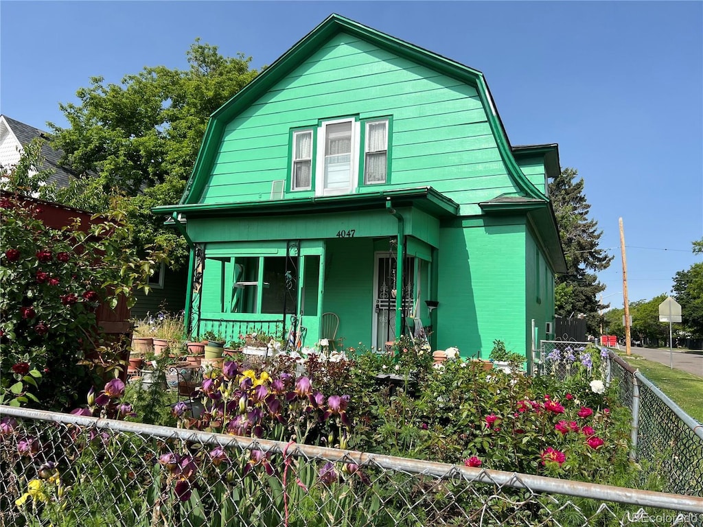 4047 Lowell Blvd, Denver, CO 80211 - view of front of home with a gambrel roof and a porch