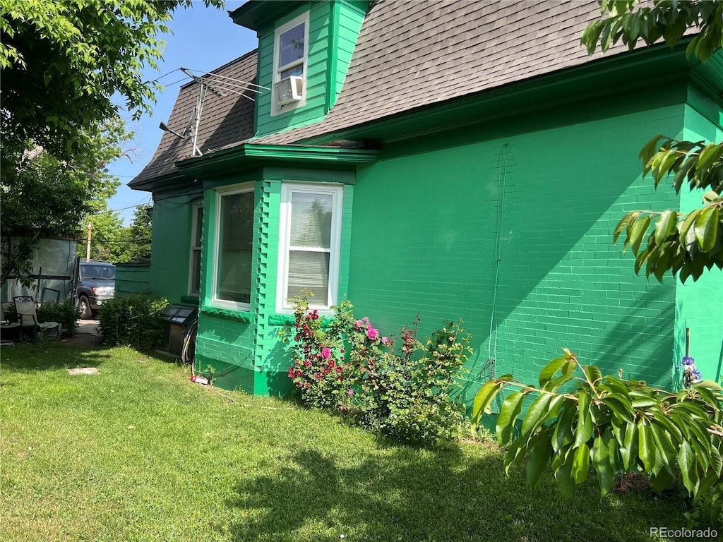 4047 Lowell Blvd, Denver, CO 80211 - view of property exterior featuring a yard and a shingled roof