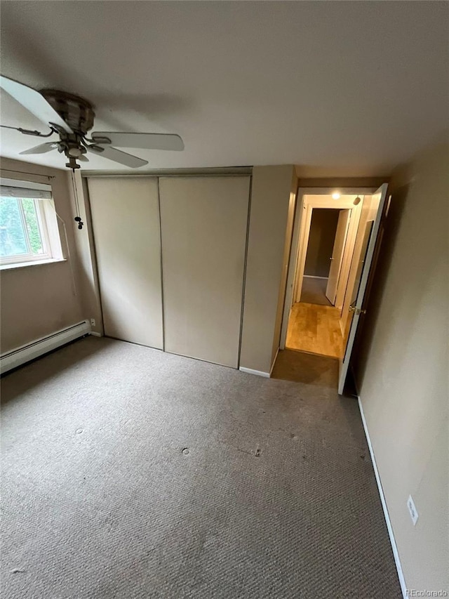 1245 N Race St Unit 306, Denver, CO 80206 - unfurnished bedroom with carpet flooring, a closet, baseboard heating, and ceiling fan