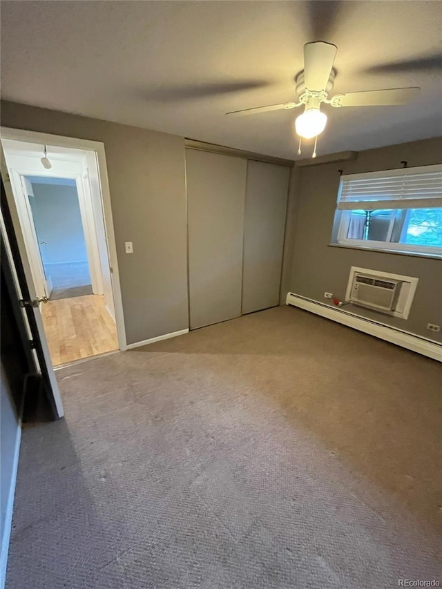 1245 N Race St Unit 306, Denver, CO 80206 - unfurnished bedroom with an AC wall unit, carpet flooring, ceiling fan, and a baseboard heating unit