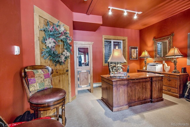 carpeted office featuring track lighting and a baseboard radiator