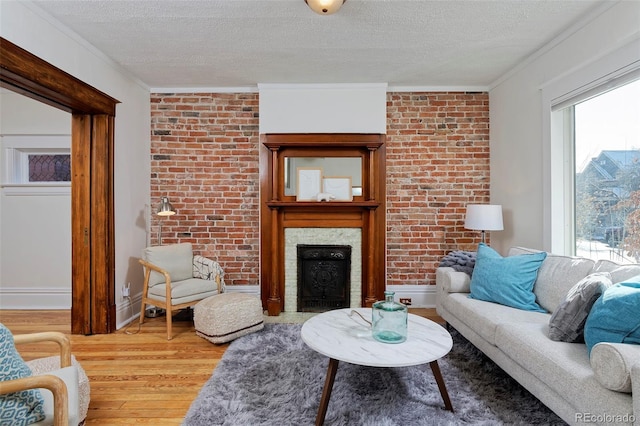 living area with light wood-style flooring, a textured ceiling, and plenty of natural light