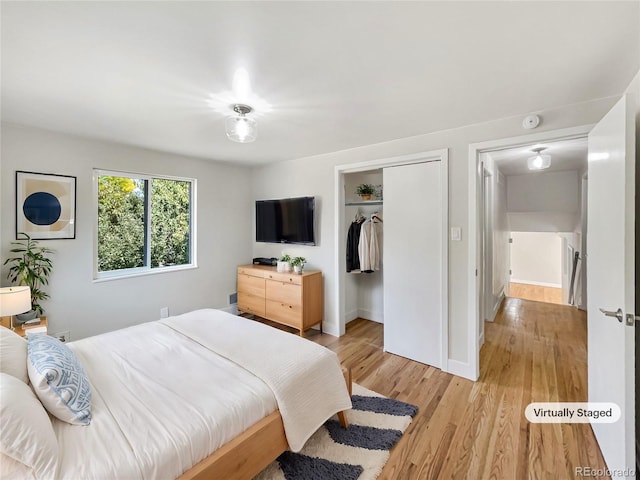 bedroom featuring a closet and light hardwood / wood-style flooring