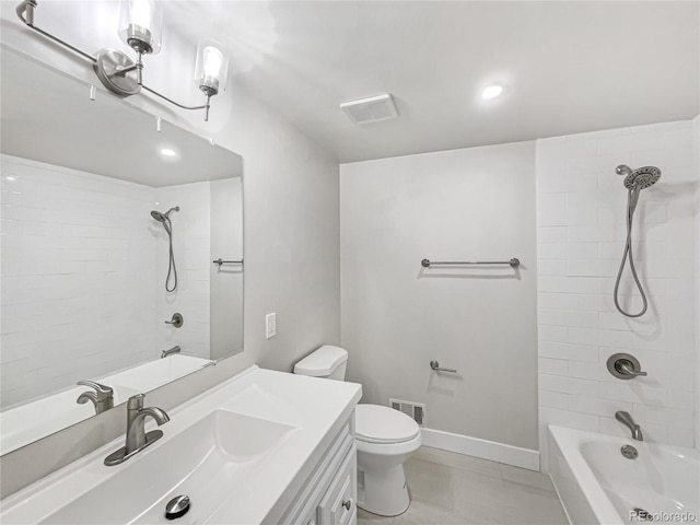 full bathroom featuring toilet, tiled shower / bath, vanity, and tile patterned flooring