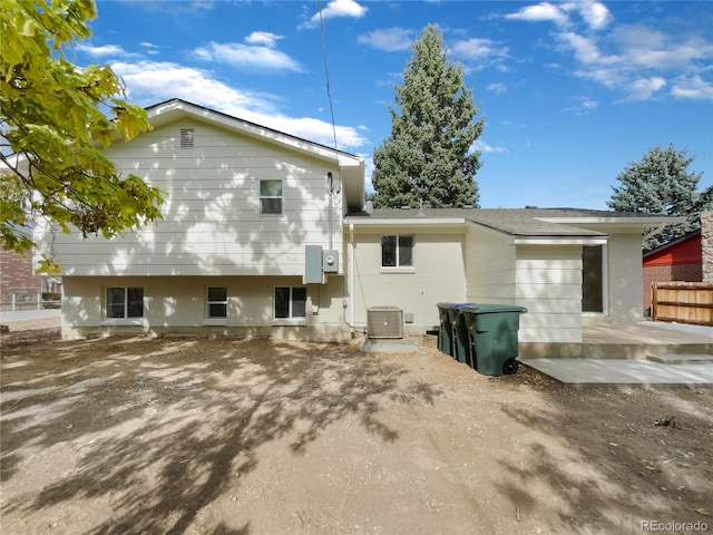 rear view of property with a patio area and central AC unit