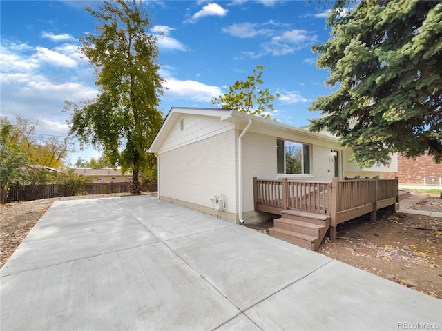 view of side of home featuring a patio and a deck