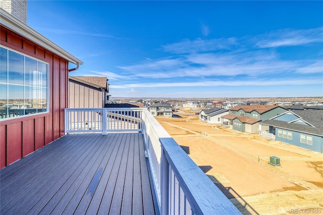 wooden terrace featuring a residential view and central AC unit