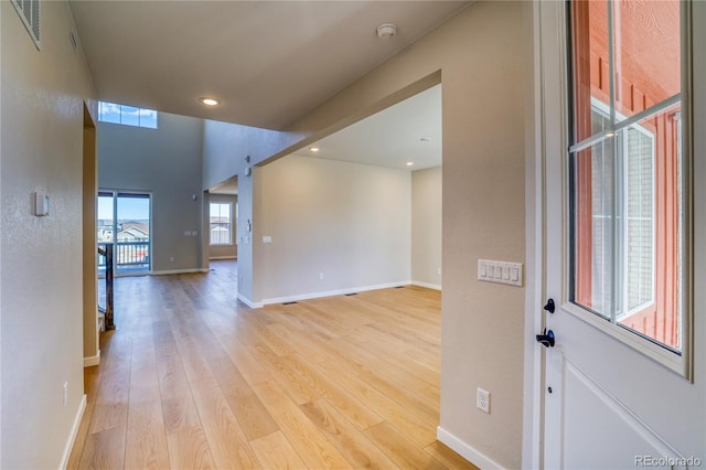 empty room featuring recessed lighting, baseboards, visible vents, and light wood finished floors