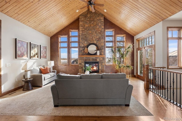 living room with a wealth of natural light, a fireplace, high vaulted ceiling, and wood ceiling