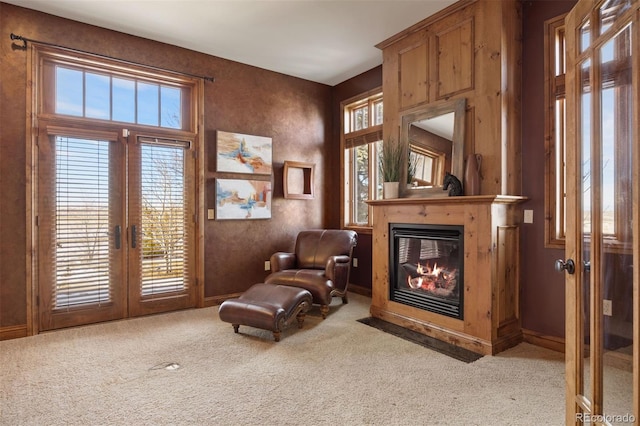 living area with french doors and light colored carpet