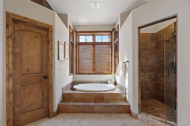 bathroom featuring separate shower and tub