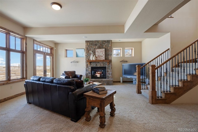 carpeted living room featuring a healthy amount of sunlight and a fireplace