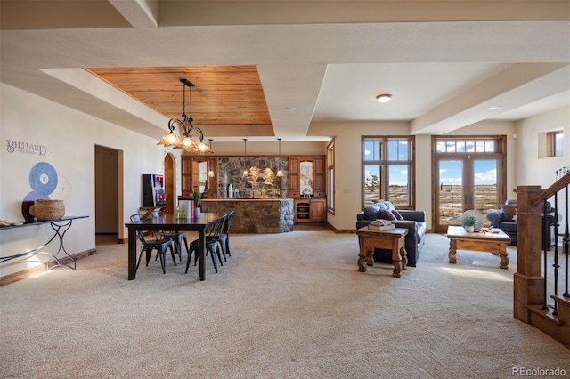 carpeted dining room featuring wood ceiling