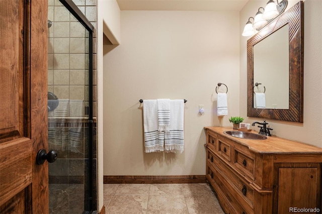 bathroom featuring an enclosed shower, vanity, and tile patterned flooring