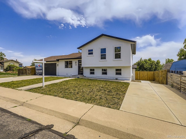 2830 E 99th Way, Thornton, CO 80229 - split level home featuring concrete driveway, a garage, and stucco siding