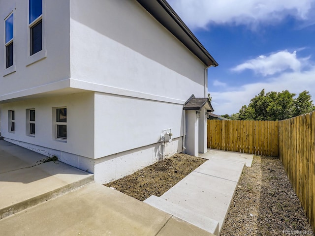 2830 E 99th Way, Thornton, CO 80229 - view of home's exterior with a fenced backyard, stucco siding, and a patio area