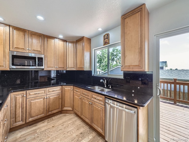 2830 E 99th Way, Thornton, CO 80229 - kitchen with stainless steel appliances, tasteful backsplash, light wood-style floors, recessed lighting, and brown cabinets