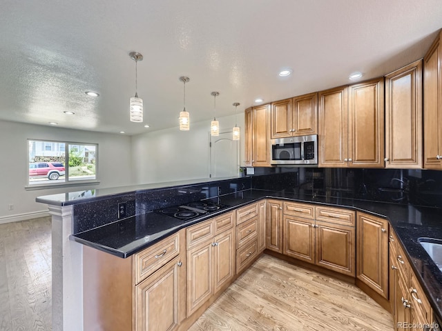 2830 E 99th Way, Thornton, CO 80229 - kitchen featuring stainless steel microwave, a peninsula, light wood-style floors, black electric stovetop, and recessed lighting