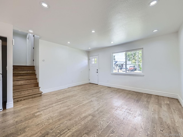 2830 E 99th Way, Thornton, CO 80229 - spare room featuring recessed lighting, stairway, and wood finished floors