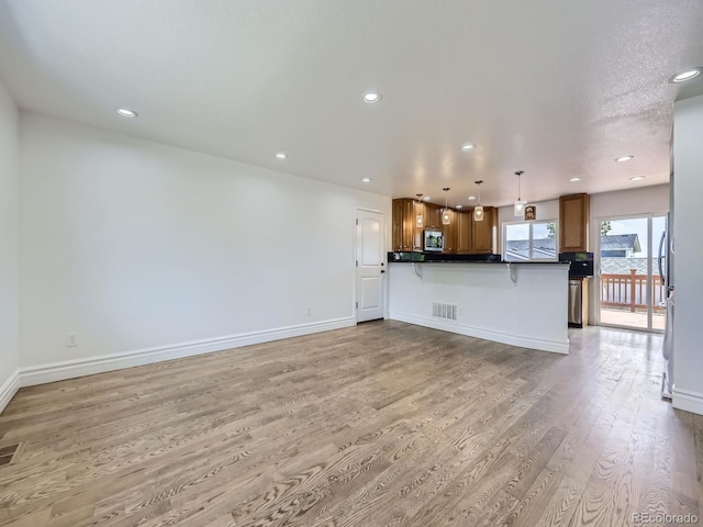 2830 E 99th Way, Thornton, CO 80229 - unfurnished living room featuring light wood-style flooring and recessed lighting