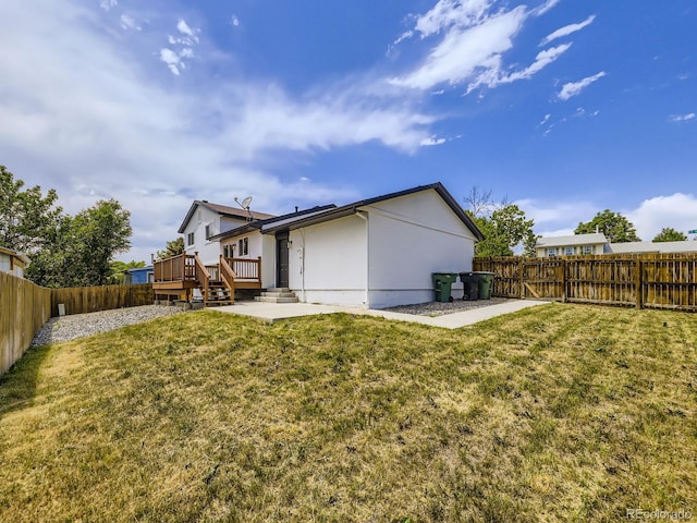 2830 E 99th Way, Thornton, CO 80229 - rear view of house featuring a fenced backyard, stucco siding, and a wooden deck