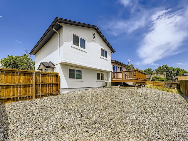 2830 E 99th Way, Thornton, CO 80229 - rear view of house featuring a wooden deck, a fenced backyard, and stucco siding