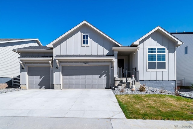 view of front facade featuring board and batten siding, an attached garage, and driveway