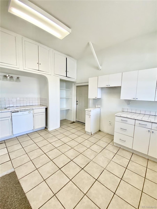 kitchen featuring white cabinetry, dishwasher, and light tile patterned floors