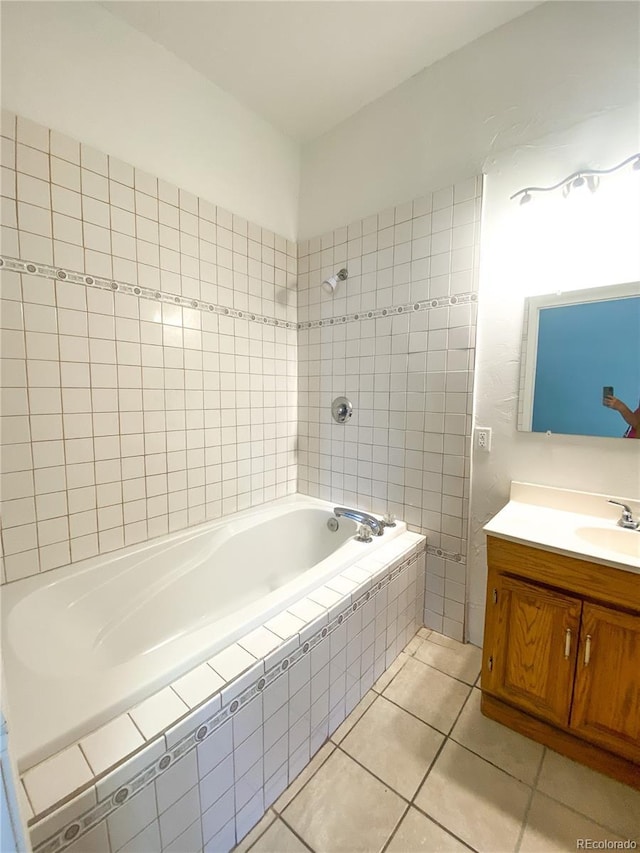 bathroom with vanity, tile patterned floors, and tiled shower / bath