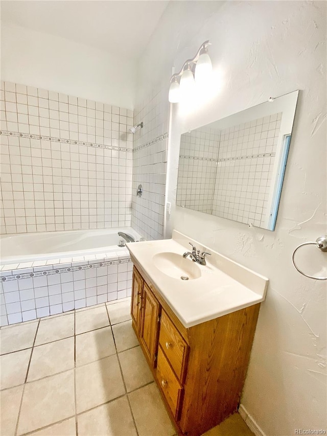 bathroom featuring tiled shower / bath combo, vanity, and tile patterned floors